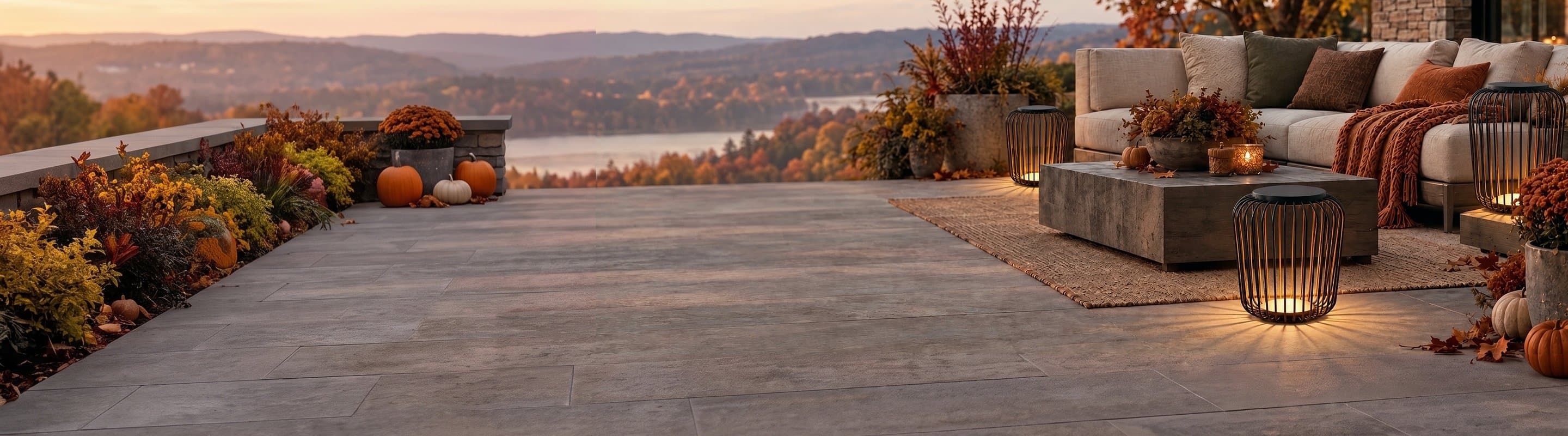 Outdoor floor lanterns glowing on an autumn terrace at dusk